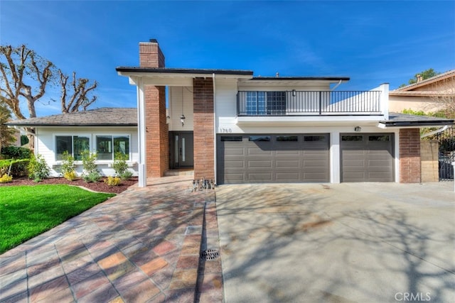 1760 N Yurok St, Orange, CA 92867 - view of front facade with a chimney, driveway, a balcony, and brick siding