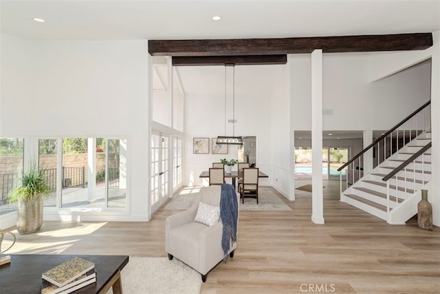 1760 N Yurok St, Orange, CA 92867 - living room featuring beam ceiling, a high ceiling, light wood finished floors, french doors, and stairs