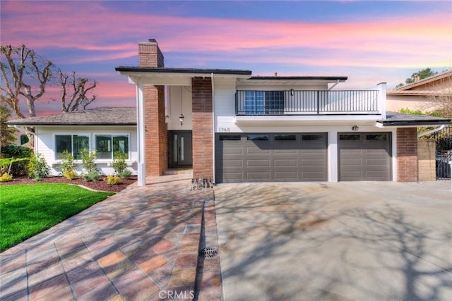 1760 N Yurok St, Orange, CA 92867 - view of front of house with a balcony, a chimney, driveway, brick siding, and an attached garage