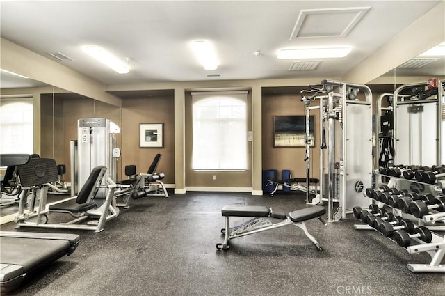 gym featuring baseboards and visible vents