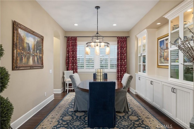 dining space featuring a chandelier, baseboards, dark wood finished floors, and recessed lighting
