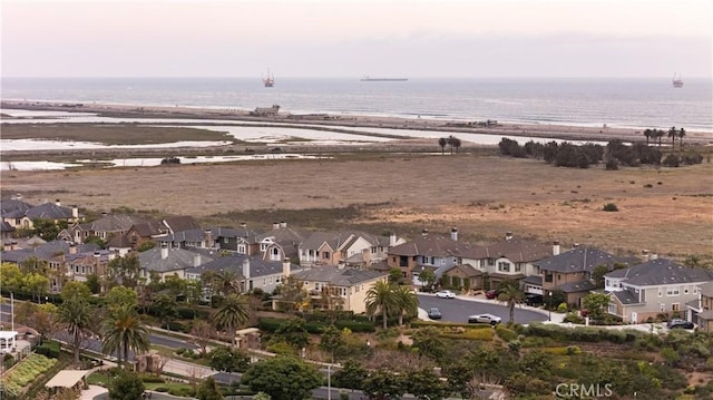 aerial view of property's location with nearby suburban area and a nearby body of water