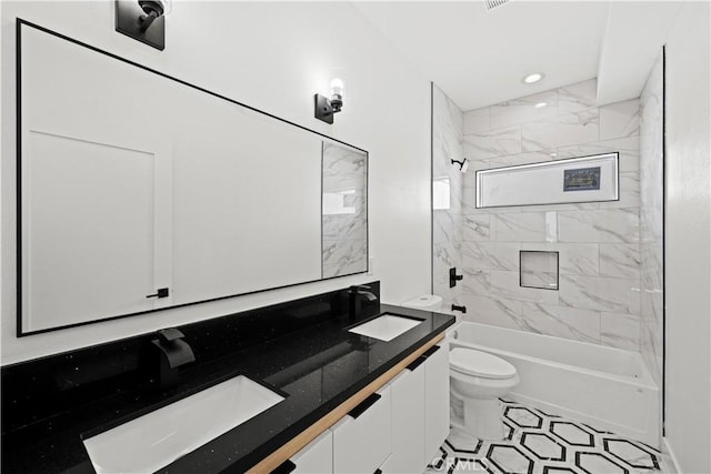full bathroom with double vanity, toilet, shower / bathing tub combination, and a sink
