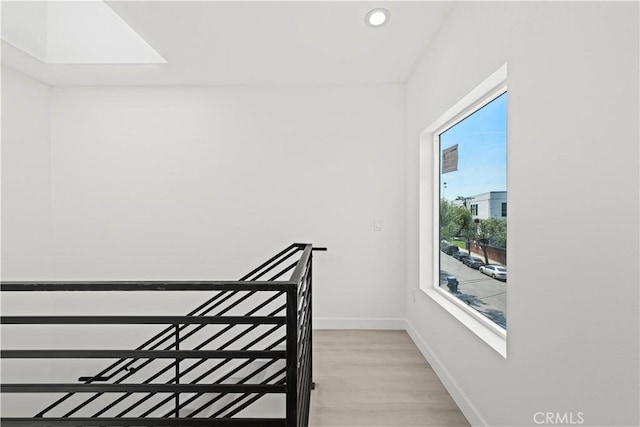 stairway featuring recessed lighting, baseboards, and wood finished floors