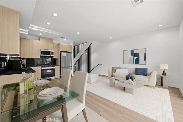 dining area with light wood-type flooring, visible vents, baseboards, and recessed lighting