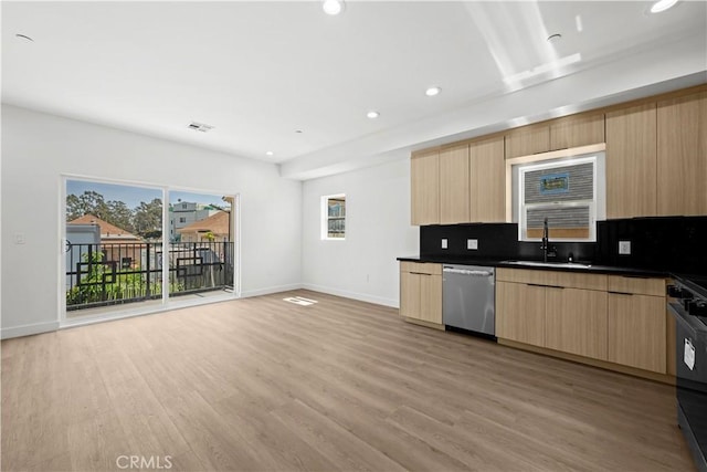kitchen featuring a sink, light brown cabinetry, stainless steel dishwasher, baseboards, and modern cabinets