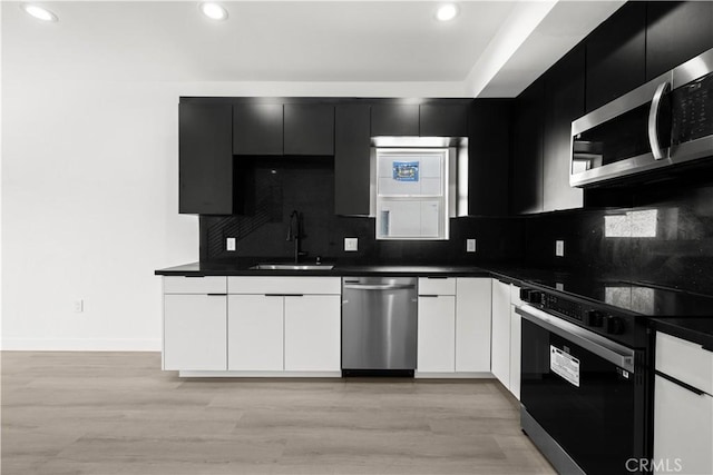 kitchen featuring dark countertops, appliances with stainless steel finishes, and a sink