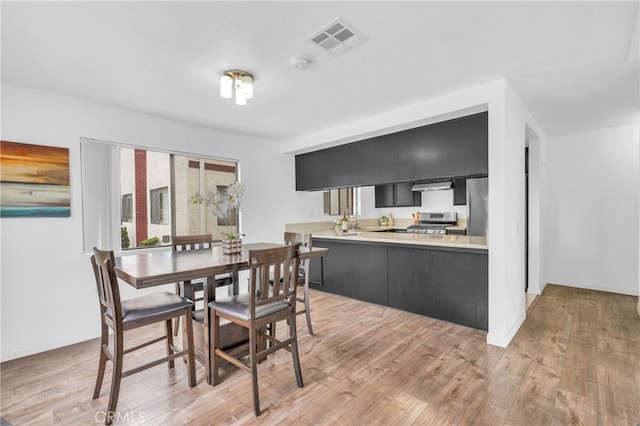 dining space featuring light wood finished floors