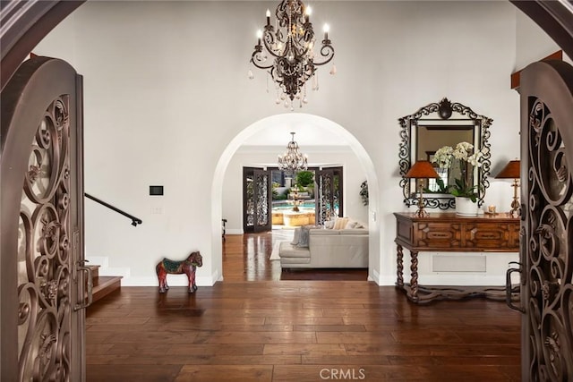 9 Maverick Ln, Bell Canyon, CA 91307 - entryway featuring a chandelier, arched walkways, wood-type flooring, stairs, and baseboards