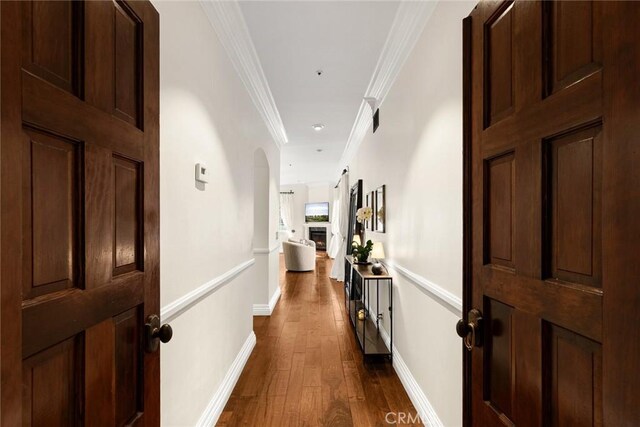 9 Maverick Ln, Bell Canyon, CA 91307 - hallway with dark wood-style flooring, ornamental molding, arched walkways, and baseboards