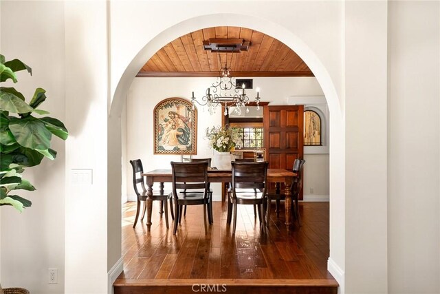 9 Maverick Ln, Bell Canyon, CA 91307 - dining space featuring wooden ceiling, arched walkways, dark wood-type flooring, baseboards, and a chandelier