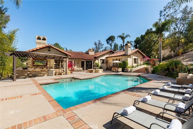 9 Maverick Ln, Bell Canyon, CA 91307 - view of swimming pool with an outdoor kitchen, a patio area, and a pool with connected hot tub