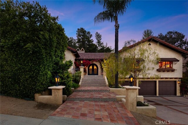 9 Maverick Ln, Bell Canyon, CA 91307 - mediterranean / spanish house featuring stucco siding, concrete driveway, a garage, and a tile roof