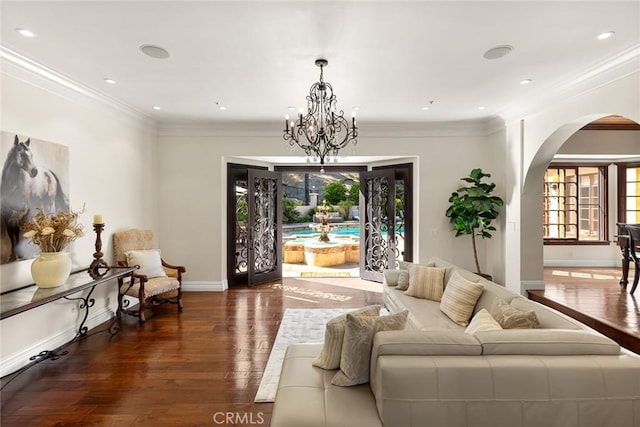 9 Maverick Ln, Bell Canyon, CA 91307 - living area with arched walkways, wood finished floors, ornamental molding, baseboards, and a chandelier