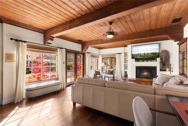 9 Maverick Ln, Bell Canyon, CA 91307 - living area featuring wood ceiling with exposed beams, a warm lit fireplace, dark wood-style floors, and baseboards