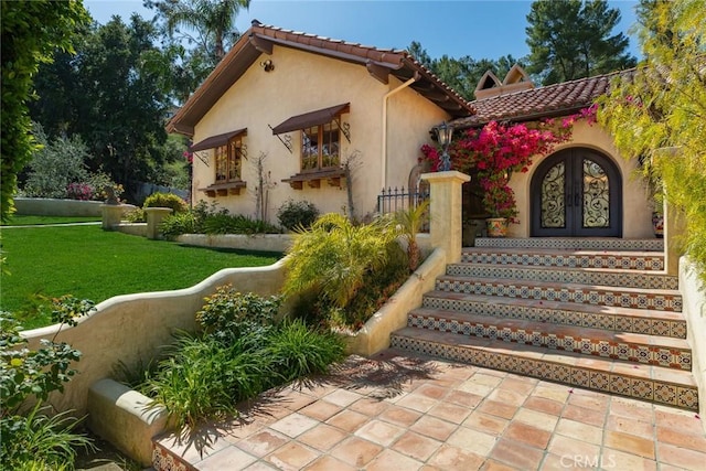 9 Maverick Ln, Bell Canyon, CA 91307 - doorway to property featuring stucco siding, a yard, a tile roof, and french doors