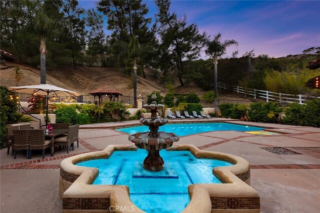 9 Maverick Ln, Bell Canyon, CA 91307 - pool at dusk featuring a patio area