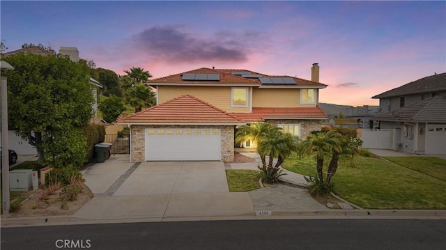 4300 Deodar Dr, Yorba Linda, CA 92886 - view of front of home with a tiled roof, concrete driveway, roof mounted solar panels, and a chimney