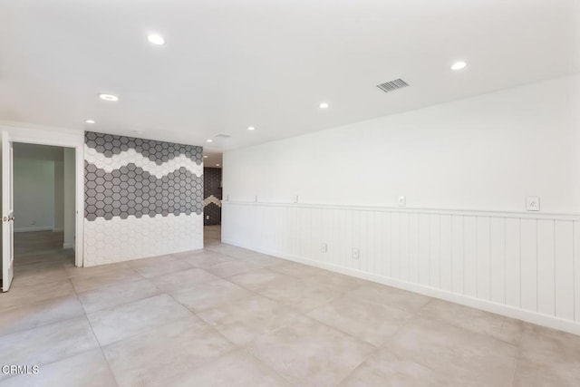 spare room featuring recessed lighting and light tile patterned floors
