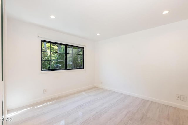 unfurnished room featuring recessed lighting and baseboards