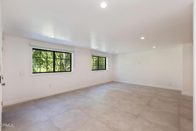 unfurnished room featuring recessed lighting and baseboards