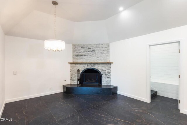 unfurnished living room with marble look tiles, a large fireplace, baseboards, and high vaulted ceiling
