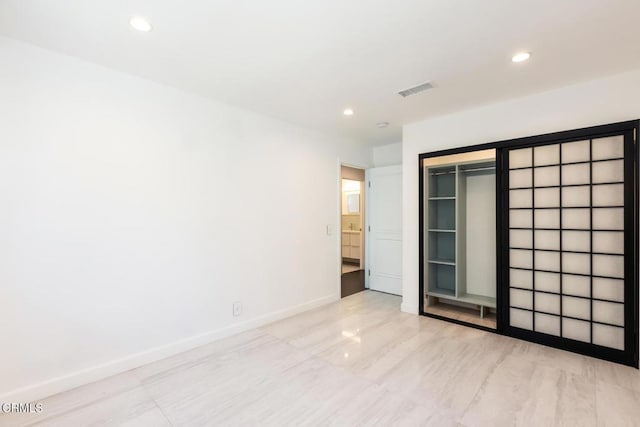 unfurnished bedroom with recessed lighting, baseboards, and a closet