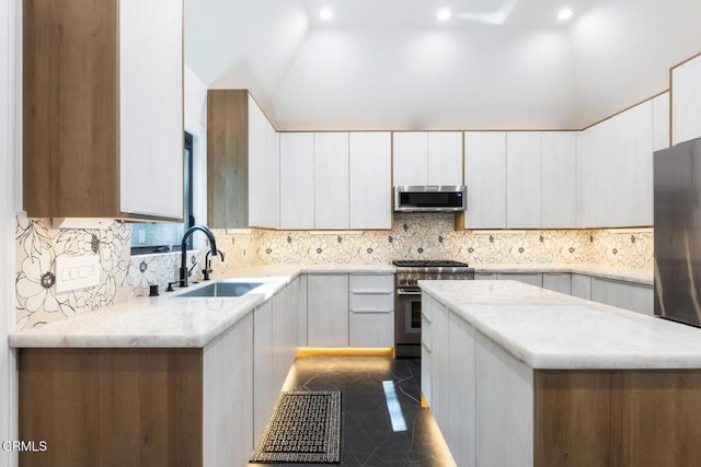 kitchen with a sink, stainless steel appliances, tasteful backsplash, recessed lighting, and light stone counters