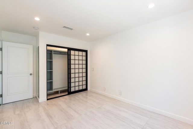 unfurnished bedroom featuring recessed lighting, baseboards, and a closet