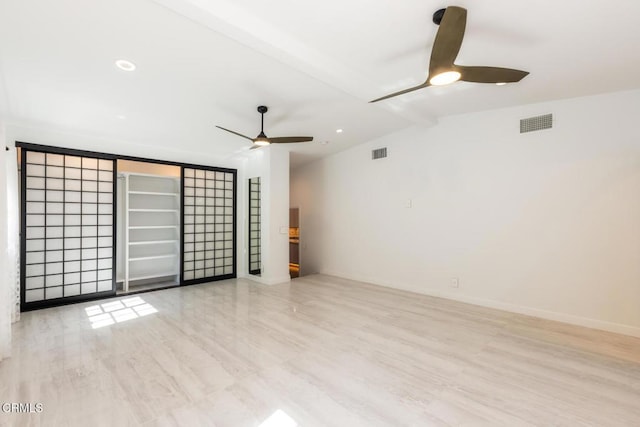 spare room with ceiling fan and baseboards