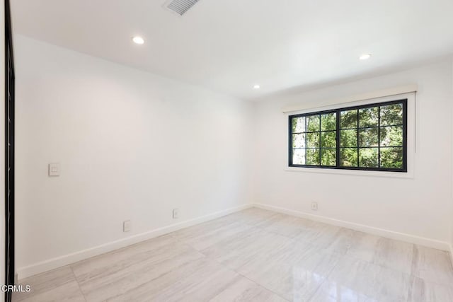 empty room with baseboards and recessed lighting