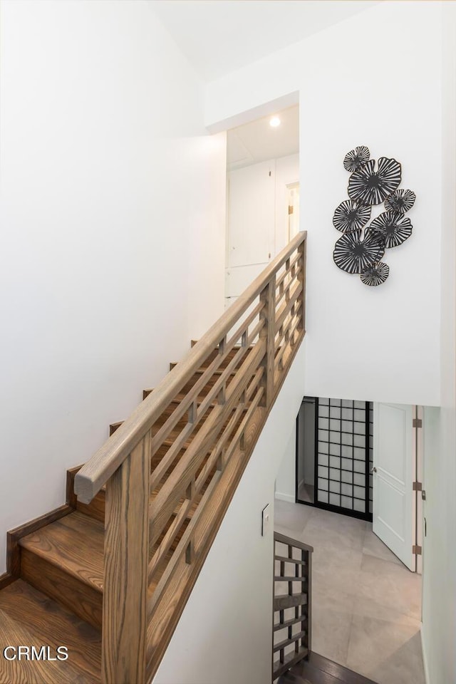 stairs with recessed lighting and baseboards