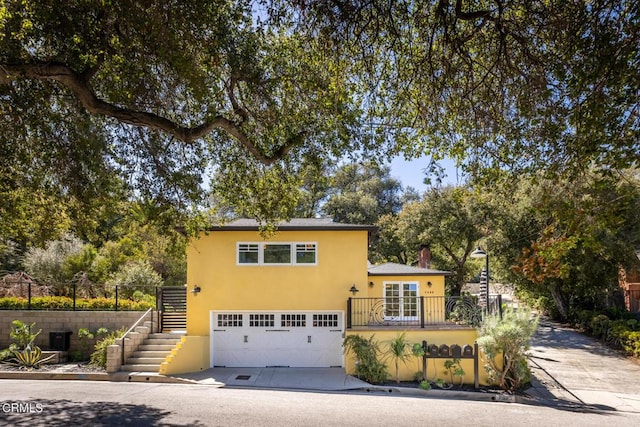 7580 Mcgroarty Ter, Tujunga, CA 91042 - view of front facade with stairs, concrete driveway, an attached garage, and stucco siding