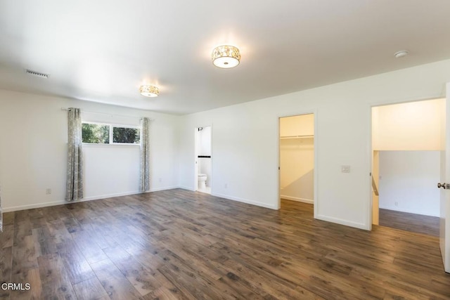 7580 Mcgroarty Ter, Tujunga, CA 91042 - unfurnished bedroom featuring dark wood-style floors, a spacious closet, baseboards, and ensuite bath