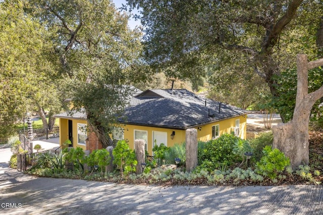 7580 Mcgroarty Ter, Tujunga, CA 91042 - view of front of property with a shingled roof, stucco siding, and fence