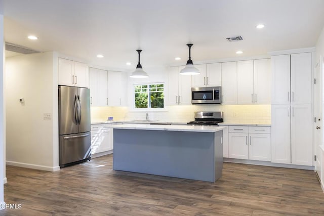 7580 Mcgroarty Ter, Tujunga, CA 91042 - kitchen with stainless steel appliances, recessed lighting, a kitchen island, white cabinets, and decorative backsplash