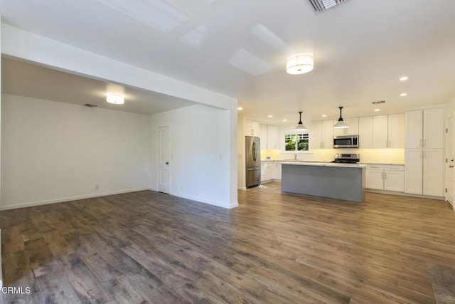 7580 Mcgroarty Ter, Tujunga, CA 91042 - kitchen featuring appliances with stainless steel finishes, white cabinetry, open floor plan, a center island, and recessed lighting