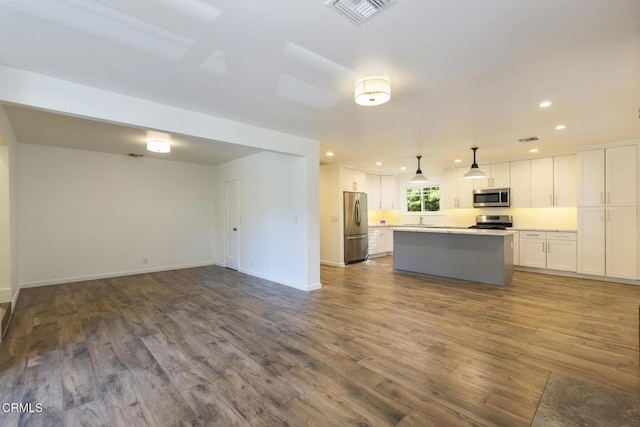7580 Mcgroarty Ter, Tujunga, CA 91042 - kitchen featuring stainless steel appliances, a center island, white cabinetry, dark wood-style floors, and open floor plan