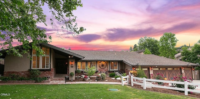 ranch-style house with brick siding, driveway, an attached garage, and stucco siding