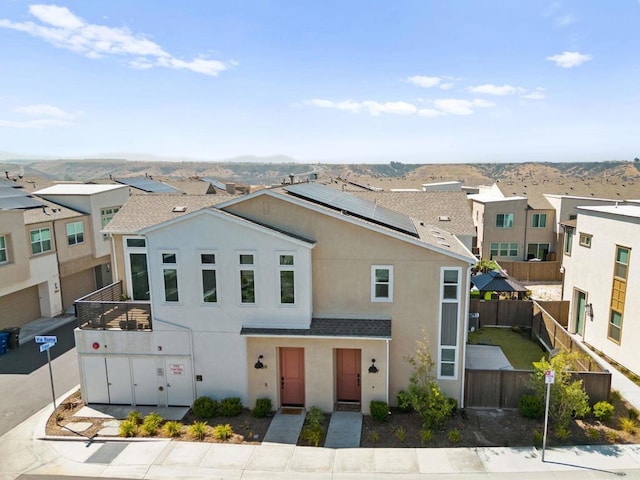 2167 Trevi Cir, Chula Vista, CA 91913 - view of front facade featuring stucco siding, roof mounted solar panels, and a residential view