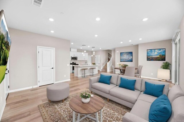 2167 Trevi Cir, Chula Vista, CA 91913 - living area with stairs, light wood-style floors, and recessed lighting