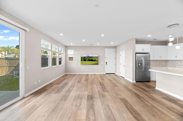 2167 Trevi Cir, Chula Vista, CA 91913 - unfurnished living room with light wood finished floors and recessed lighting