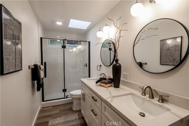29521 Via, San Sebastian, Laguna Niguel, CA 92677 - full bath featuring a skylight, toilet, wood finished floors, double vanity, and a shower stall