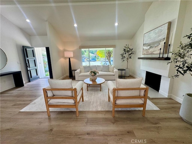 29521 Via, San Sebastian, Laguna Niguel, CA 92677 - living area with lofted ceiling, a fireplace, wood finished floors, recessed lighting, and baseboards