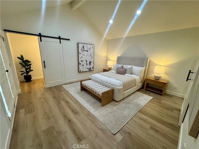 29521 Via, San Sebastian, Laguna Niguel, CA 92677 - bedroom with a barn door, beamed ceiling, light wood-style floors, baseboards, and high vaulted ceiling