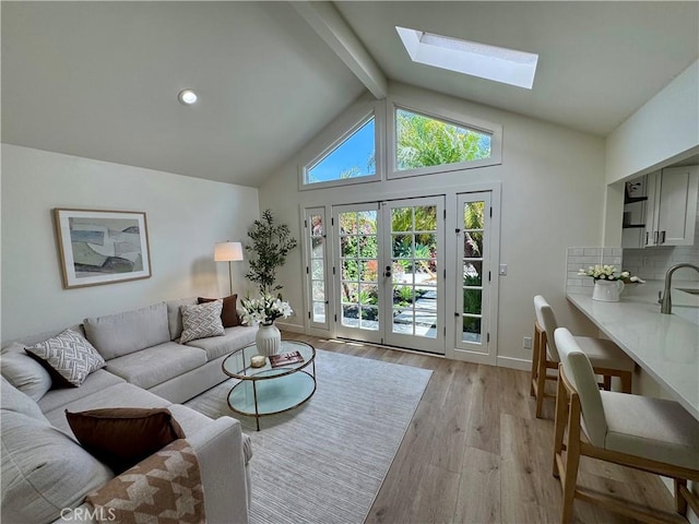 29521 Via, San Sebastian, Laguna Niguel, CA 92677 - living area featuring a skylight, light wood finished floors, baseboards, and french doors