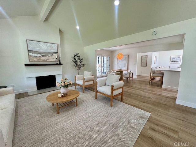 29521 Via, San Sebastian, Laguna Niguel, CA 92677 - living area featuring beam ceiling, wood finished floors, baseboards, a fireplace, and high vaulted ceiling