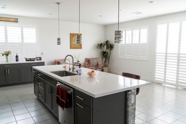 2373 Crater Ave, Rialto, CA 92377 - kitchen featuring a sink, stainless steel dishwasher, light tile patterned floors, and plenty of natural light