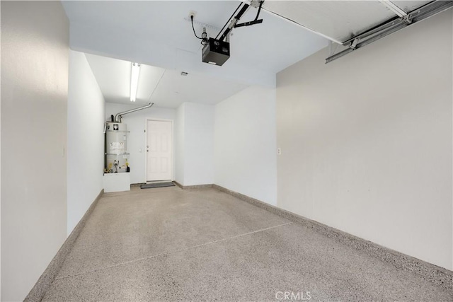 garage featuring water heater and a garage door opener