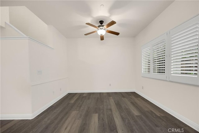unfurnished room featuring ceiling fan, wood finished floors, and baseboards